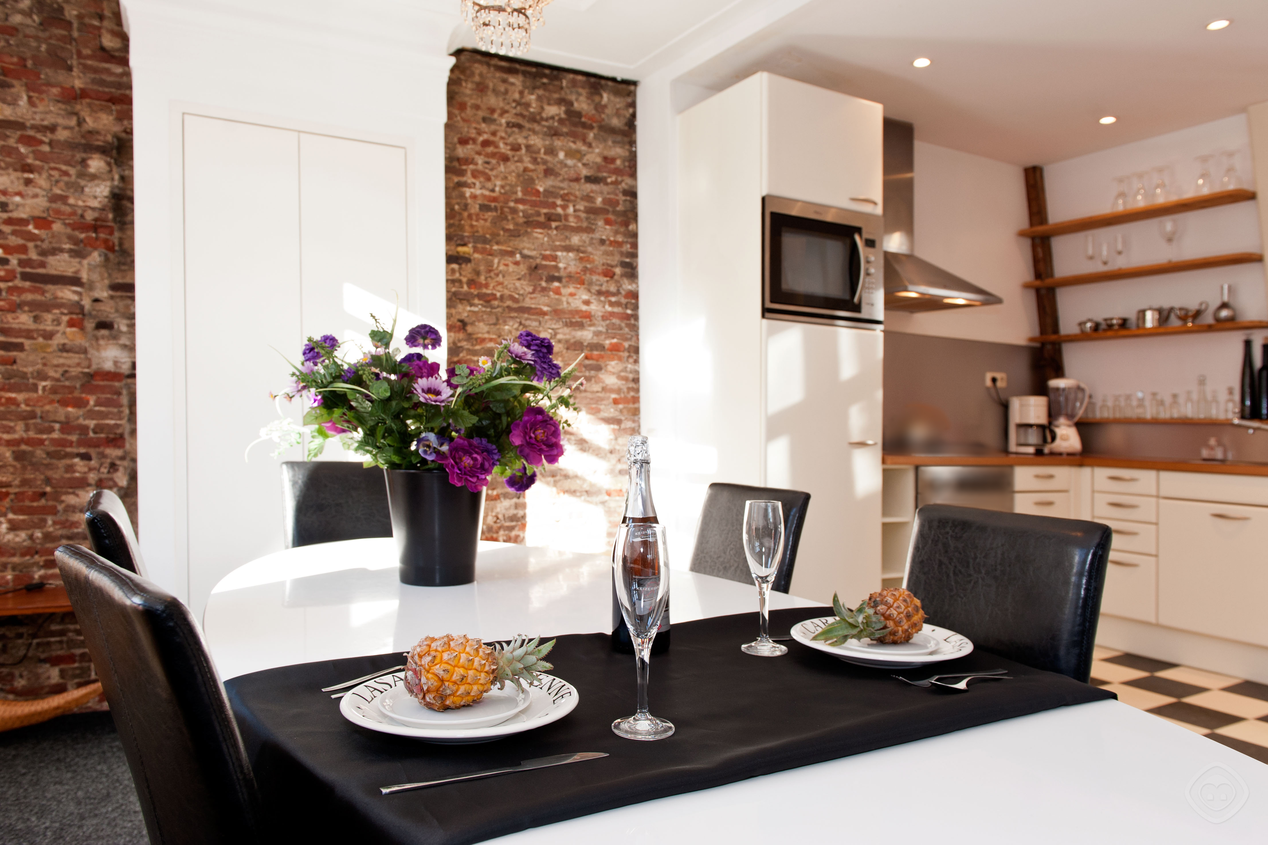 Dining table with the view of kitchen other angle Canal Holiday apartment Amsterdam