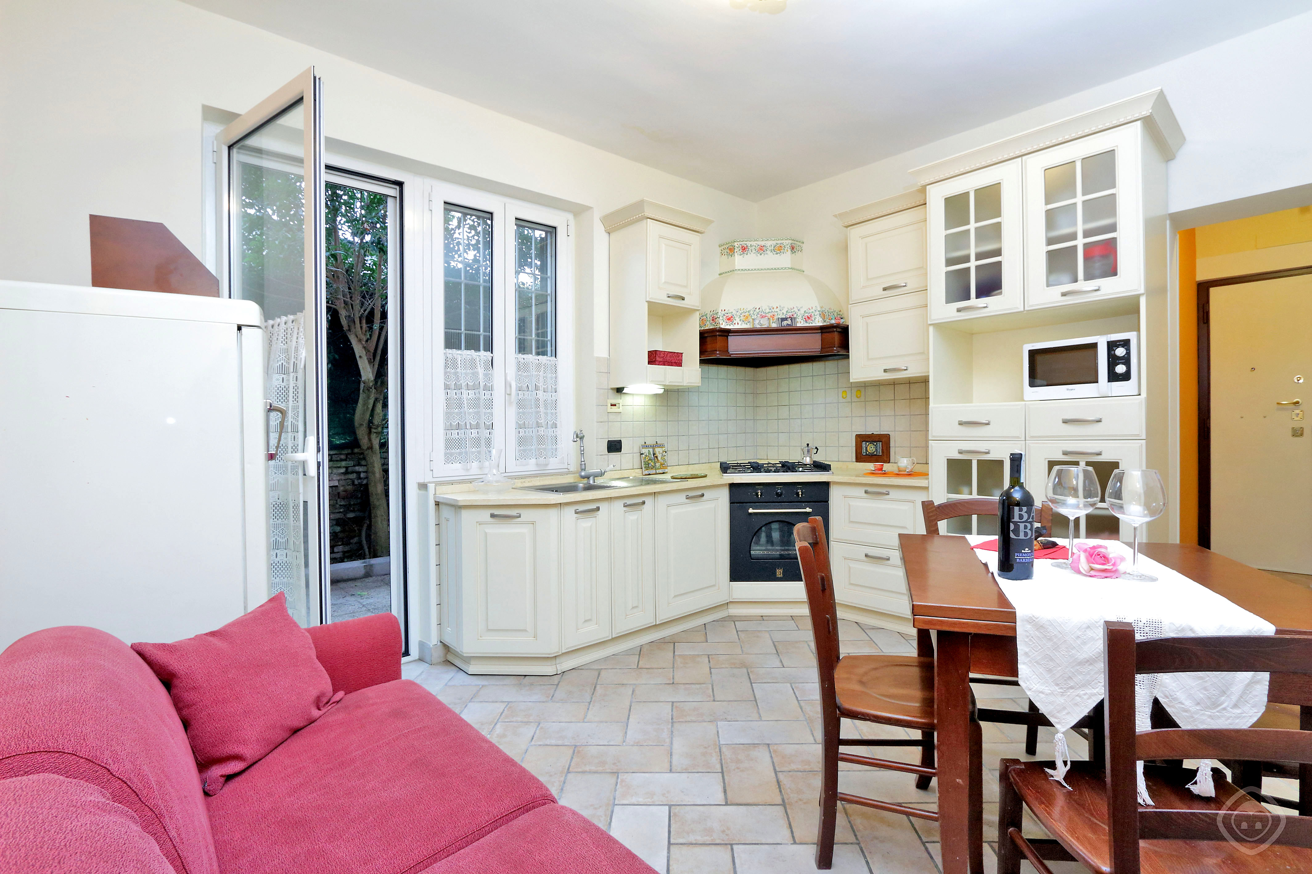 Sofa and Dining Table with the View of Kitchen Appia Park apartment Rome