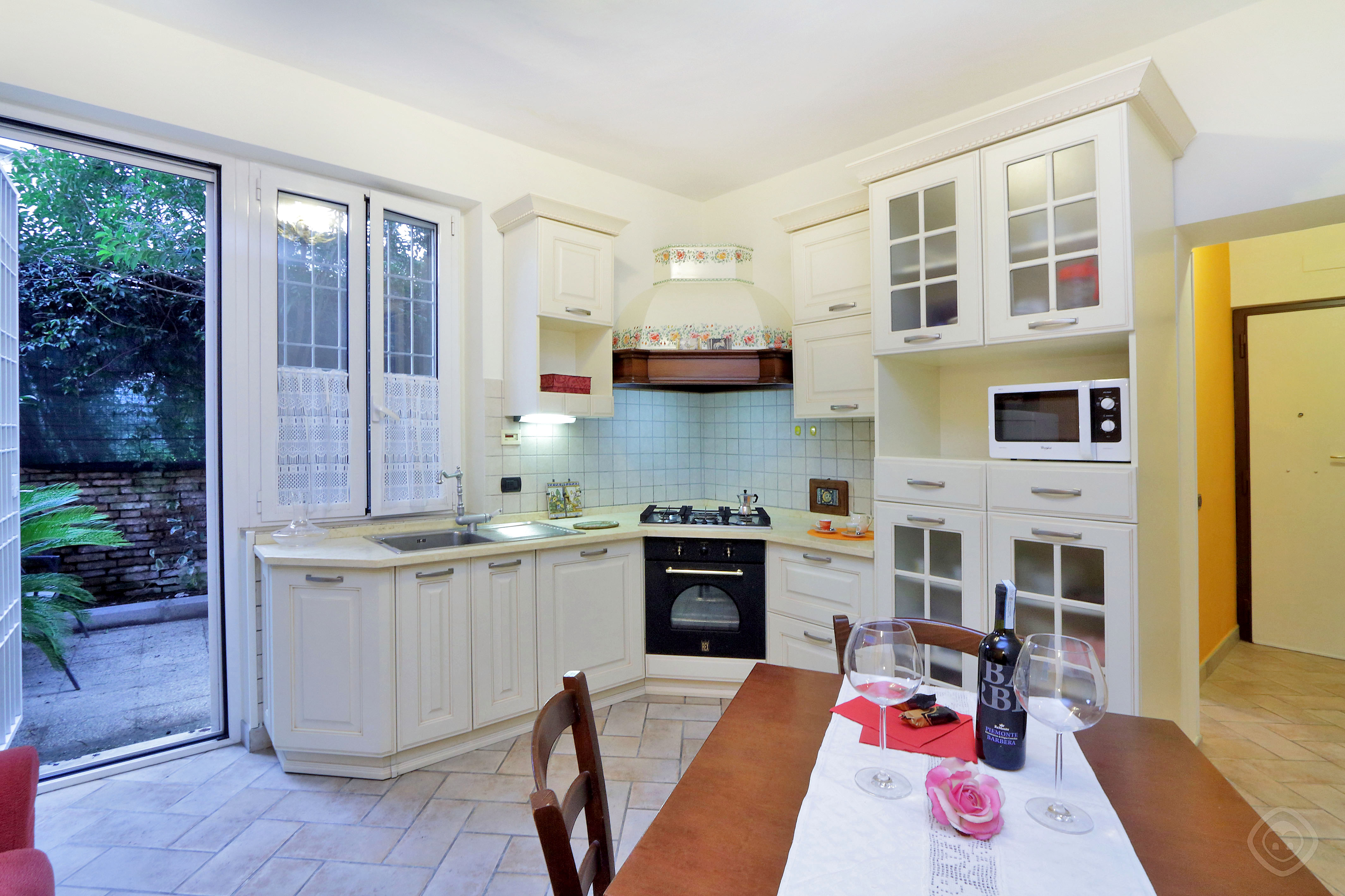 Dining Table with the View of Kitchen Appia Park apartment Rome